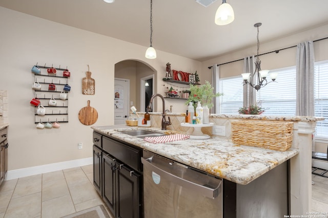 kitchen with dishwasher, sink, hanging light fixtures, a notable chandelier, and an island with sink