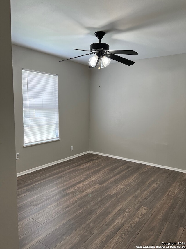 spare room with ceiling fan and dark hardwood / wood-style flooring