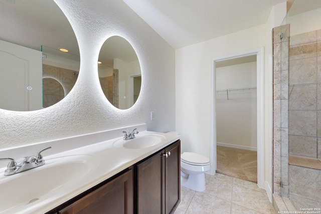 bathroom with tile patterned flooring, vanity, and toilet