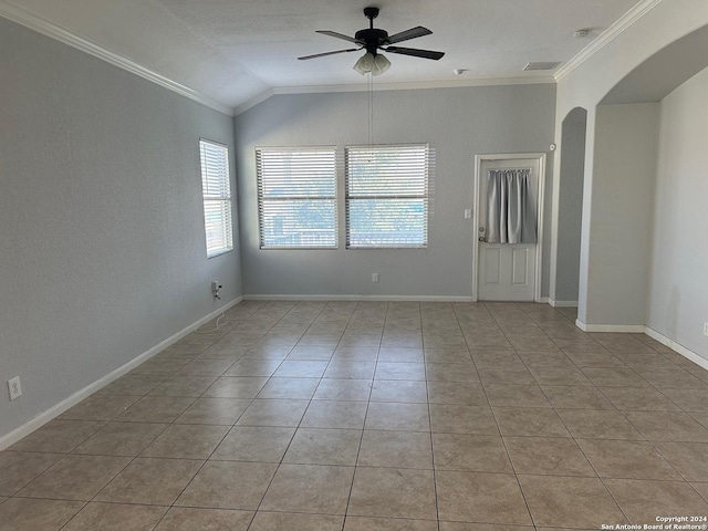 tiled spare room featuring a textured ceiling, ceiling fan, vaulted ceiling, and ornamental molding