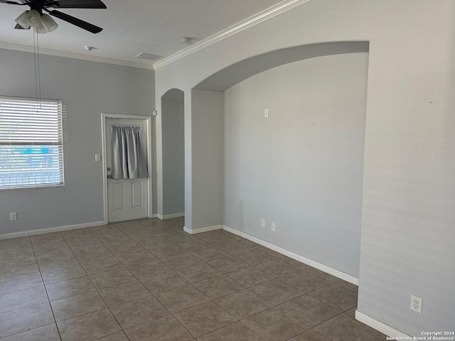 unfurnished room with tile patterned flooring, ceiling fan, and crown molding