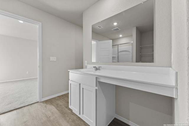 bathroom with hardwood / wood-style floors and vanity