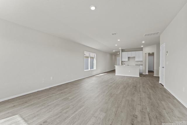 unfurnished living room featuring light hardwood / wood-style floors