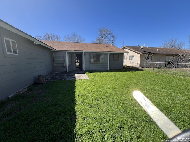 rear view of property with a yard