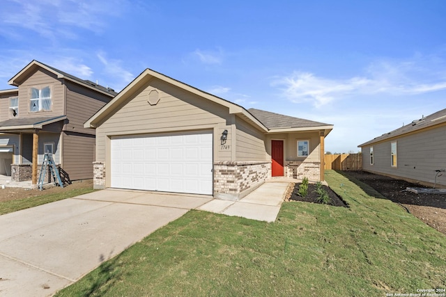 view of front of home with a garage and a front yard