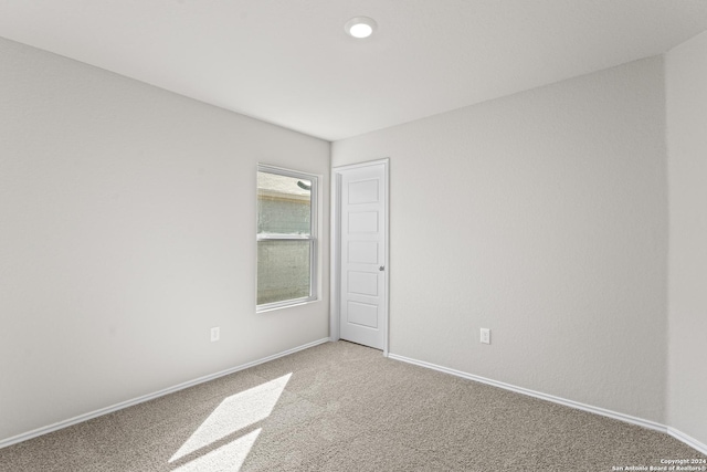 unfurnished room featuring light colored carpet