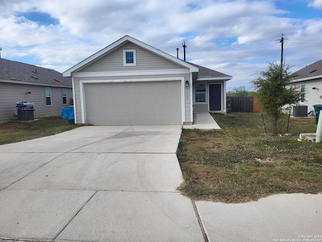 ranch-style home with cooling unit, a front yard, and a garage