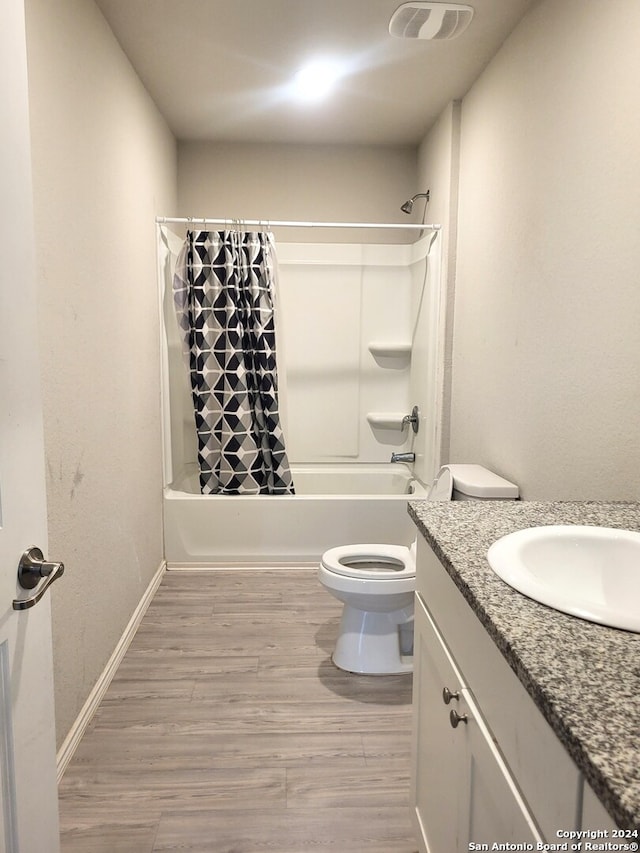 full bathroom with toilet, vanity, shower / tub combo, and hardwood / wood-style flooring