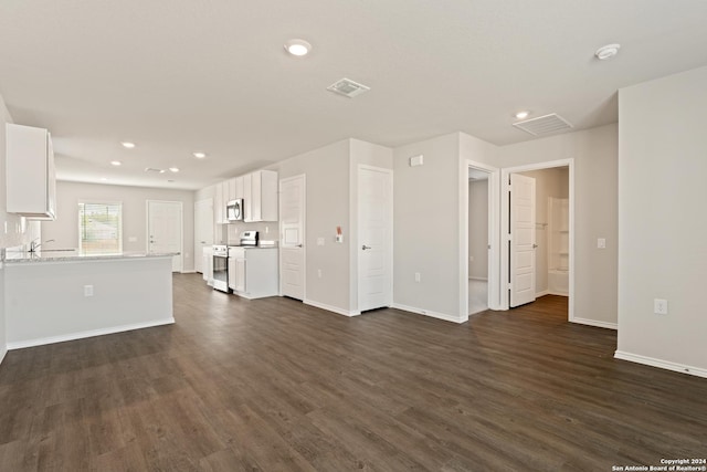 unfurnished living room with dark hardwood / wood-style flooring