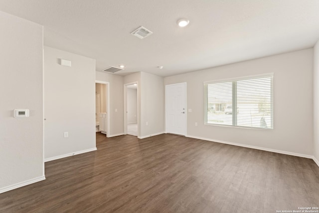 unfurnished room with dark wood-type flooring