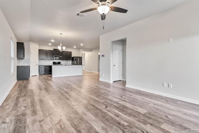 unfurnished living room with light hardwood / wood-style floors and ceiling fan with notable chandelier