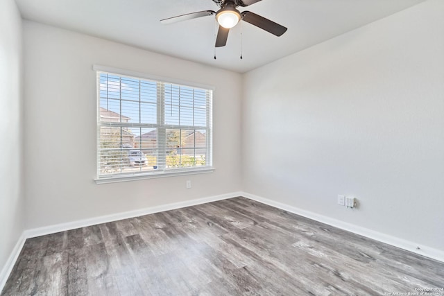 empty room featuring hardwood / wood-style flooring and ceiling fan