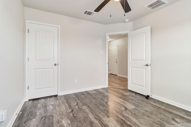 unfurnished bedroom with ceiling fan and hardwood / wood-style floors