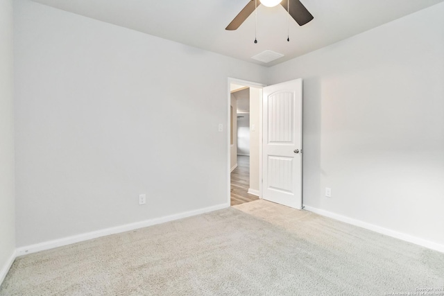 unfurnished room with ceiling fan and light colored carpet