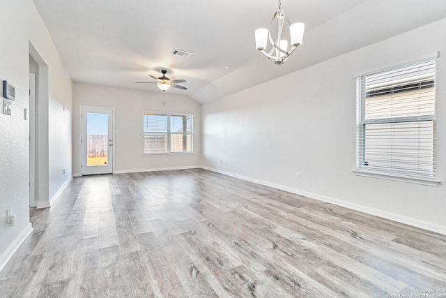 unfurnished room with ceiling fan with notable chandelier, light hardwood / wood-style floors, and lofted ceiling