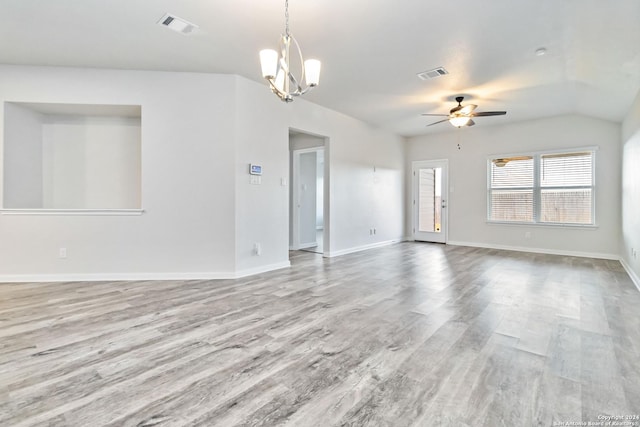 unfurnished living room featuring ceiling fan with notable chandelier and light hardwood / wood-style floors