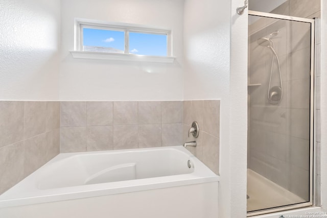 bathroom with separate shower and tub