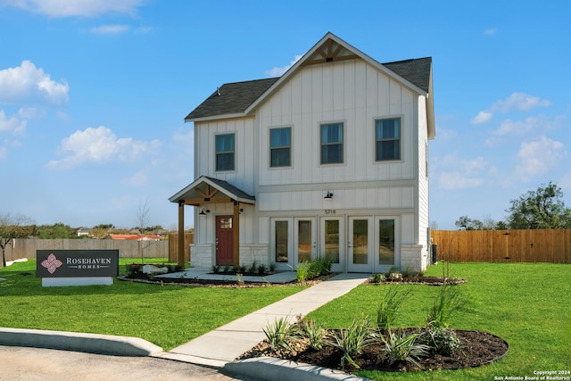 view of front of house featuring french doors and a front lawn