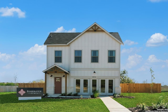 view of front facade featuring french doors and a front lawn