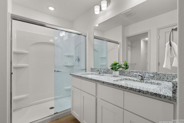 bathroom featuring vanity and an enclosed shower