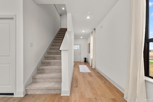 stairs featuring hardwood / wood-style floors