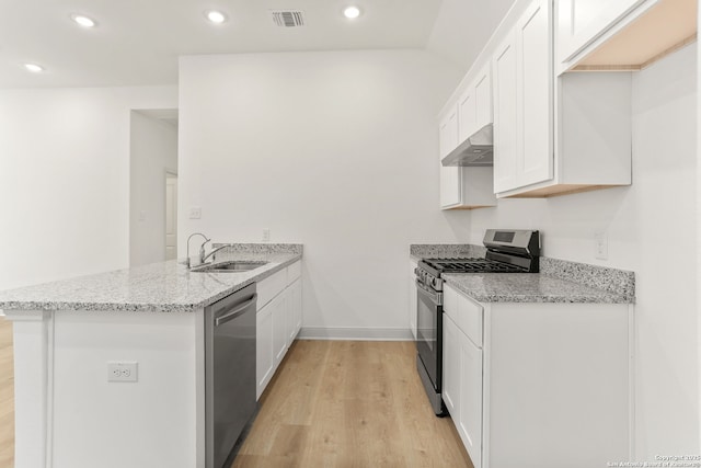 kitchen featuring range hood, a peninsula, visible vents, appliances with stainless steel finishes, and a sink