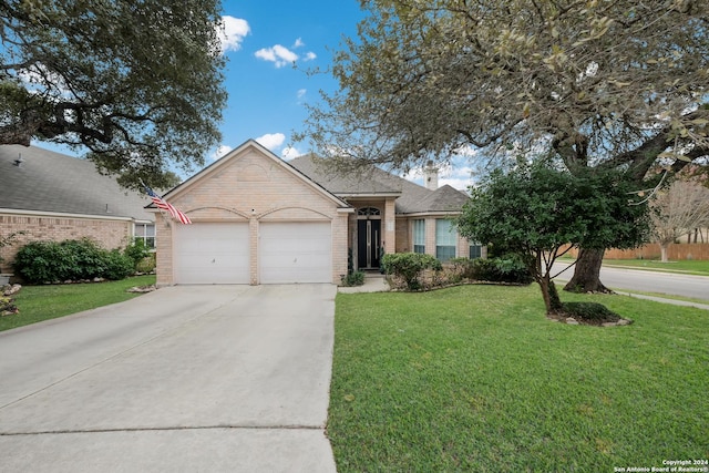 view of front of property featuring a garage and a front yard