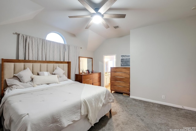 bedroom with ceiling fan, carpet, ensuite bathroom, and vaulted ceiling