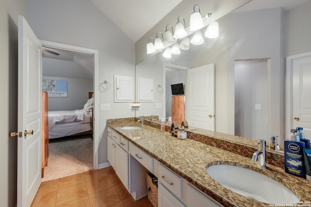 bathroom featuring vanity and lofted ceiling