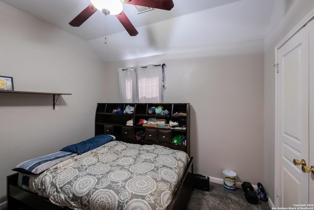 carpeted bedroom featuring a closet, ceiling fan, and lofted ceiling