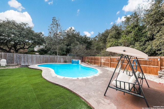 view of pool featuring a lawn and a patio