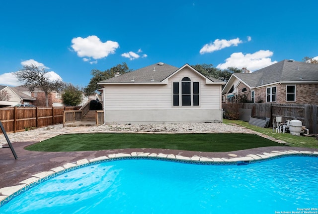 view of pool with a lawn