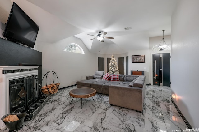 living room with ceiling fan, a premium fireplace, and vaulted ceiling