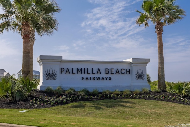 community sign featuring a lawn