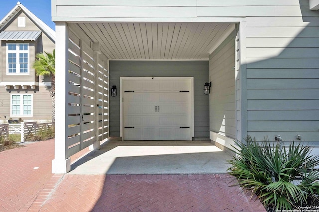 entrance to property featuring a carport and a garage