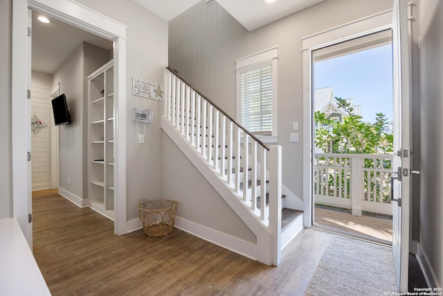 stairway with hardwood / wood-style floors