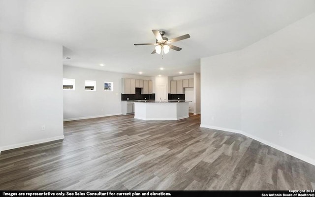 unfurnished living room featuring hardwood / wood-style floors and ceiling fan