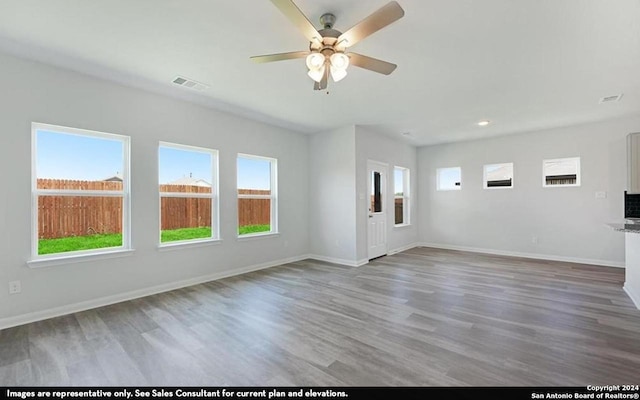 unfurnished living room featuring hardwood / wood-style flooring and ceiling fan