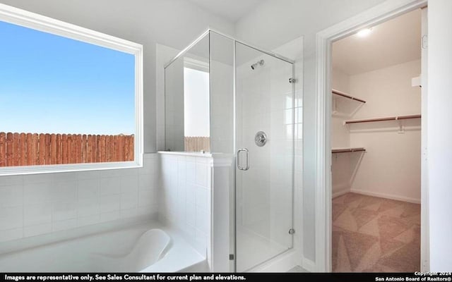 bathroom with separate shower and tub and plenty of natural light