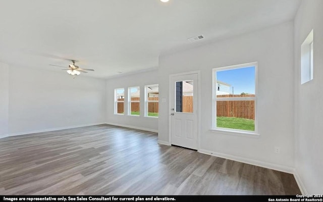 unfurnished room with wood-type flooring and ceiling fan