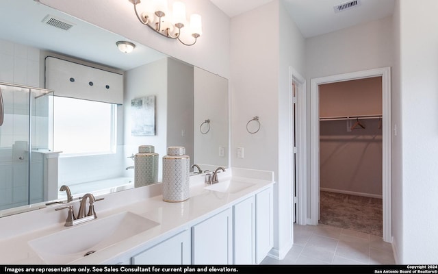 bathroom featuring tile patterned flooring, shower with separate bathtub, and vanity