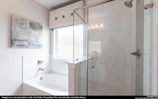 bathroom featuring shower with separate bathtub