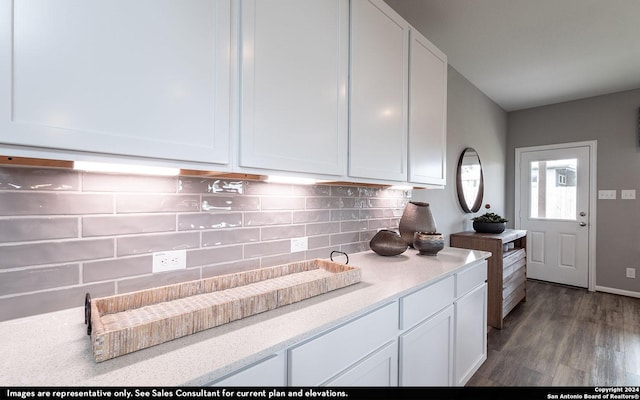 kitchen with tasteful backsplash, white cabinetry, and dark hardwood / wood-style floors