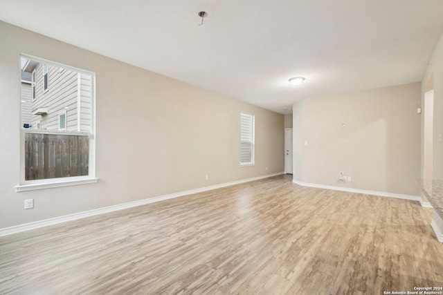 spare room with light hardwood / wood-style flooring