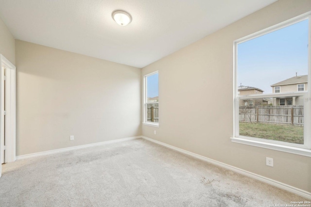 unfurnished room with light colored carpet