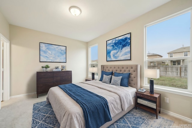 bedroom featuring light colored carpet