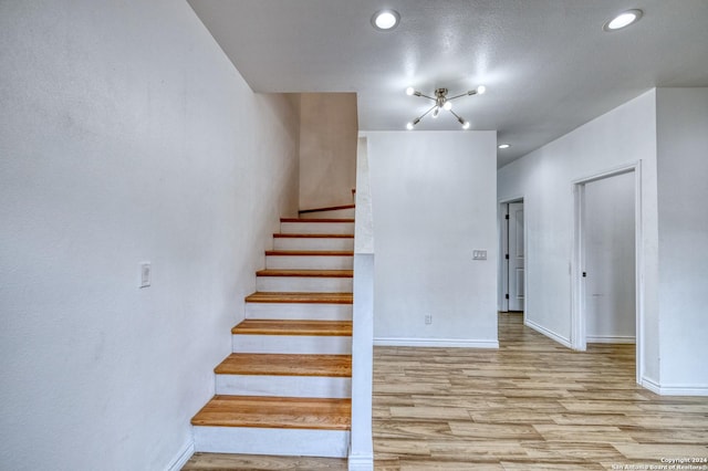 stairs featuring wood-type flooring