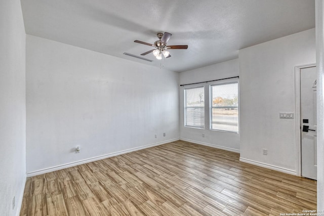 spare room featuring ceiling fan and light wood-type flooring