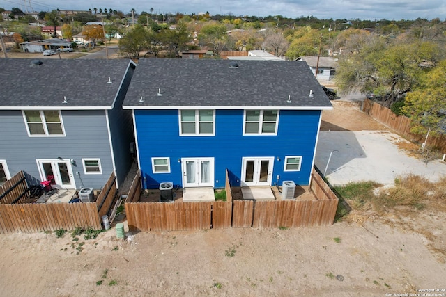 back of property featuring french doors and cooling unit