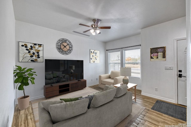 living room with ceiling fan and light wood-type flooring